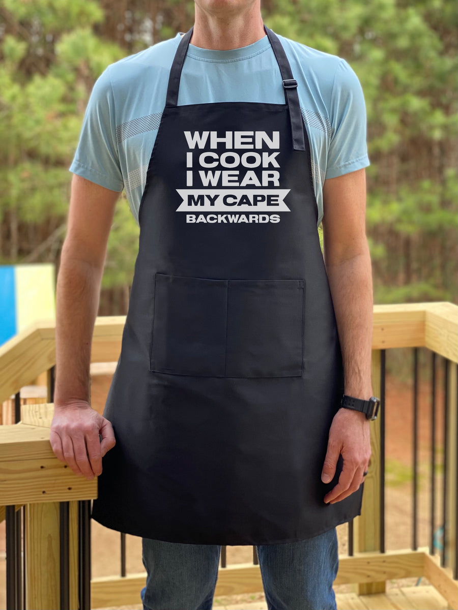 WHAT ON EARTH Cape Backwards Apron - Funny Kitchen Apron, Black Cooking  Smock